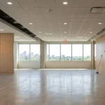 Empty commercial suite mid turnover with flattened cardboard stacked against the wall